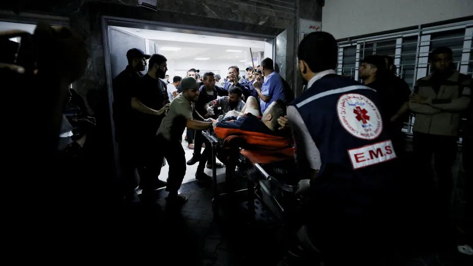 An injured person is assisted in Gaza City