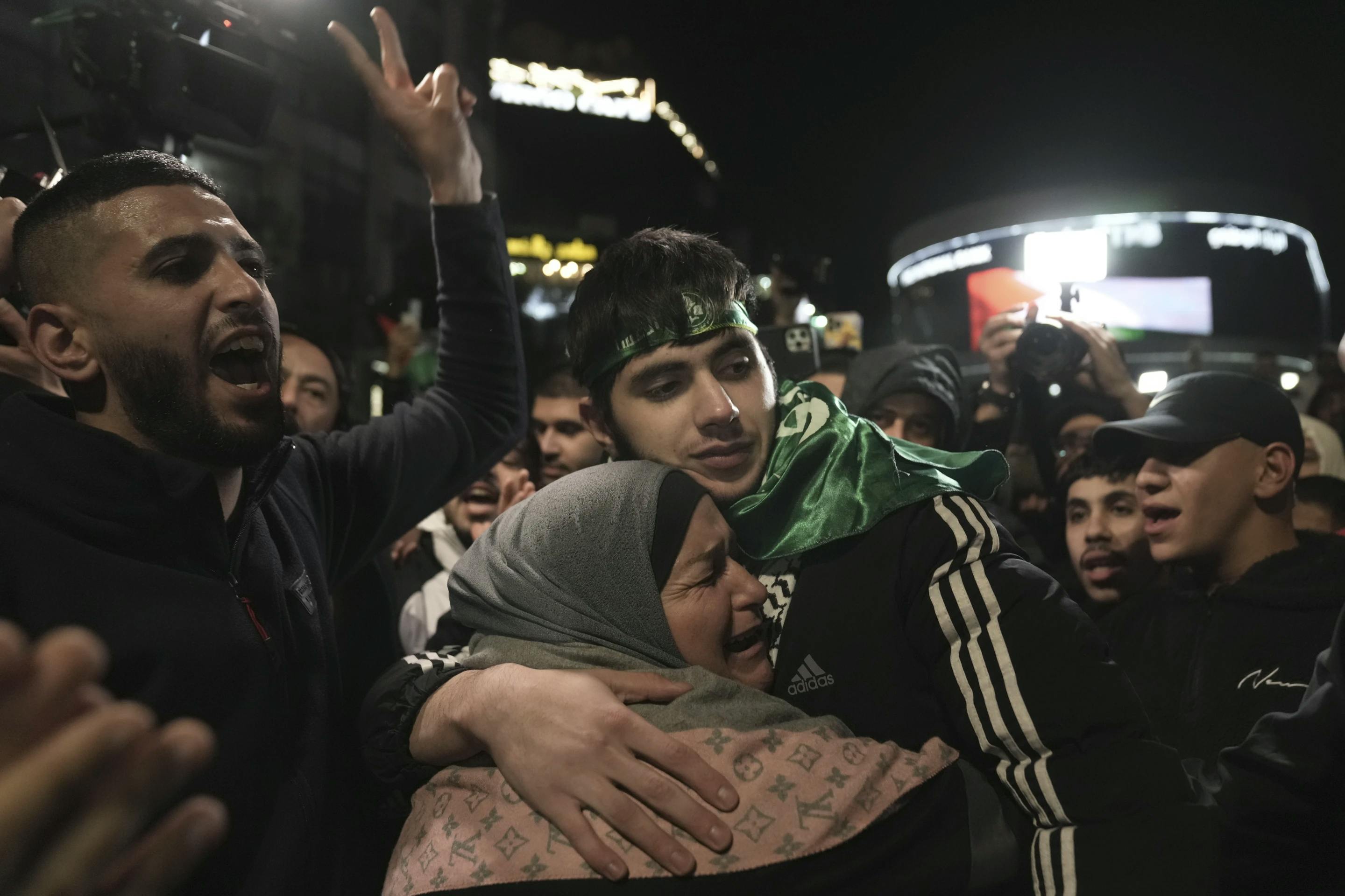 A Palestinian teen is hugged by his mother after being released from an Israeli prison