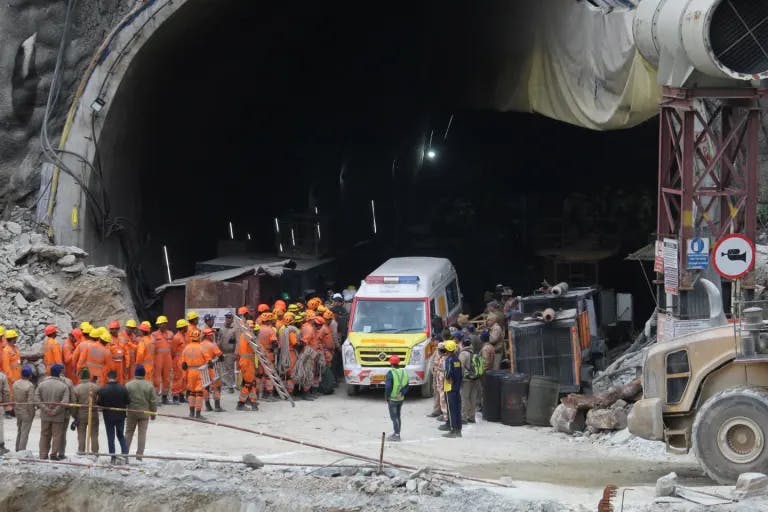 An ambulance waits to carry workers trapped in a tunnel in India