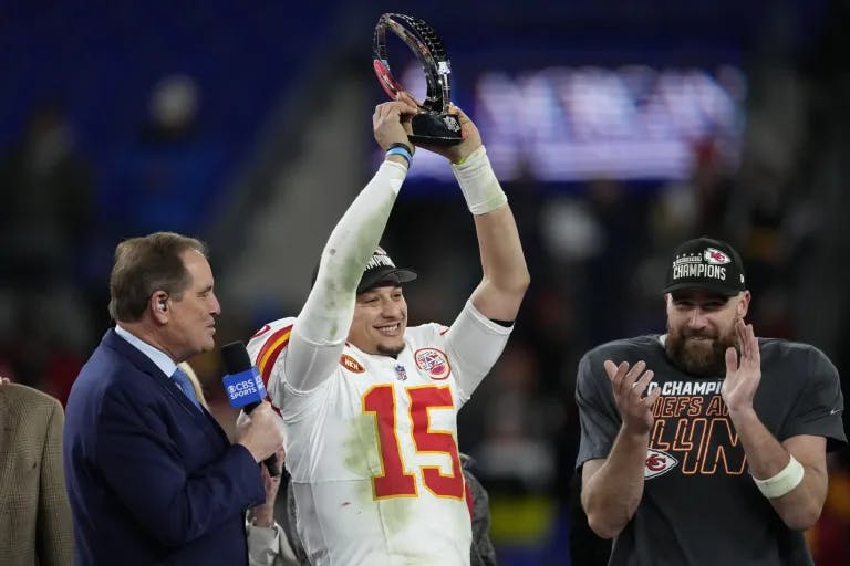Patrick Mahomes lifts the AFC Championship trophy