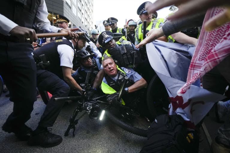 A protestor is arrested by police outside the DNC