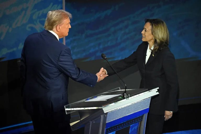 Donald Trump and Kamala Harris shake hands