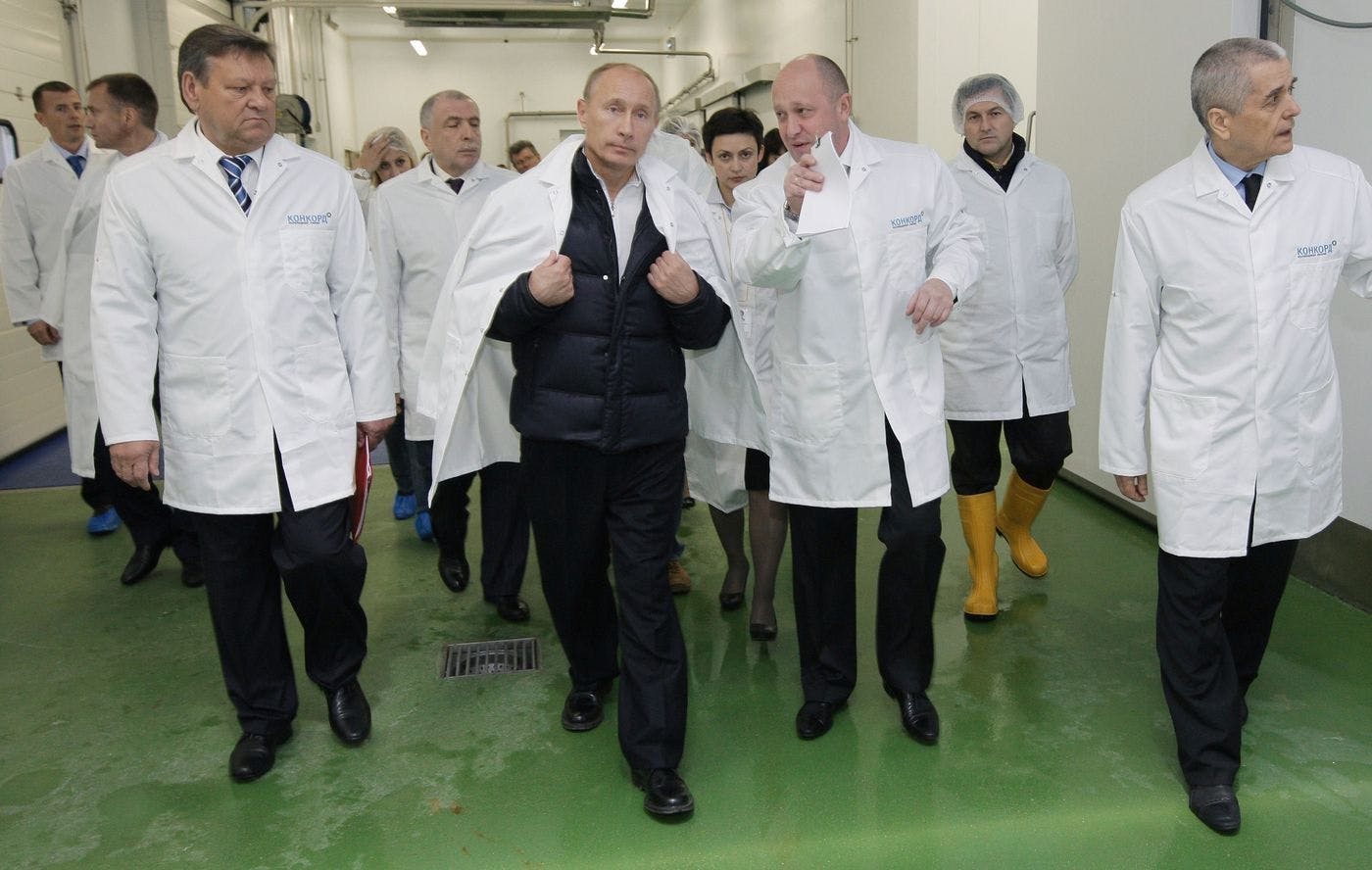 Vladimir Putin walking around a factory
